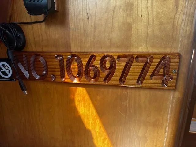 Slide: The Image of Wooden plaque with carved number "1069774" on a Freedom 35, 1998 model. - 18