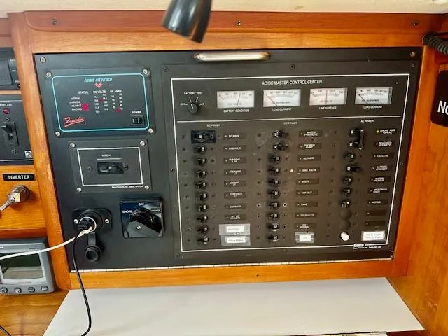 Slide: The Image of Control panel of a 1998 Freedom 35 boat with various switches and meters. - 6