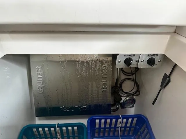 Slide: The Image of Interior of a 1998 Freedom 35 boat with electrical panel and storage baskets. - 7