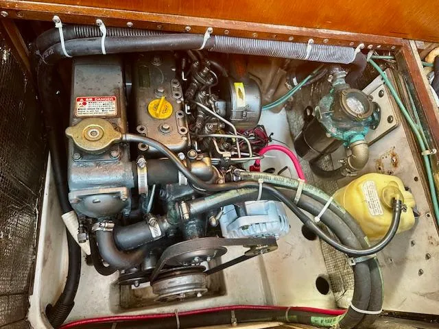 Slide: The Image of Engine compartment of a 1998 Freedom 35 sailboat, showcasing mechanical components and wiring. - 8