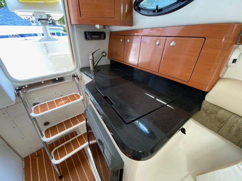 Slide: The Image of 2006 Century 2600 Walkaround boat interior with seating and storage compartments. - 17