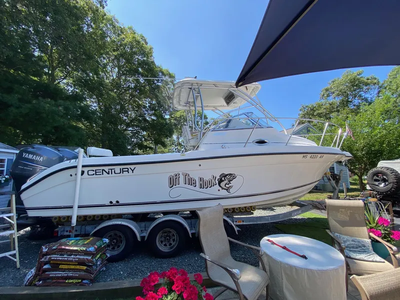 Slide: The Image of 2006 Century 2600 Walkaround boat on trailer, parked outdoors under clear blue sky. - 2