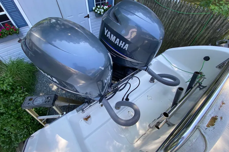 Slide: The Image of 2006 Century 2600 Walkaround boat with open storage compartments and visible engine parts. - 22