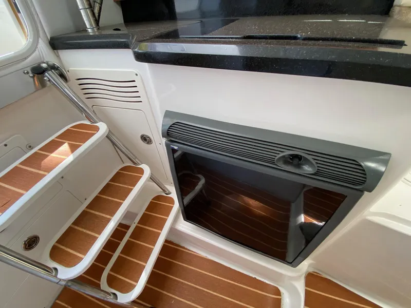 Slide: The Image of 2006 Century 2600 Walkaround interior with wooden steps and sleek black countertop. - 26