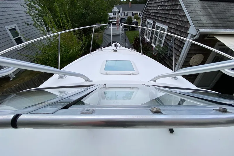 Slide: The Image of 2006 Century 2600 Walkaround boat docked between houses, view from bow. - 30