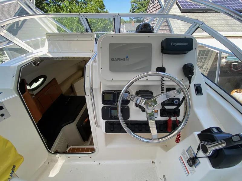 Slide: The Image of 2006 Century 2600 Walkaround boat interior with dual captain chairs and control panel. - 7