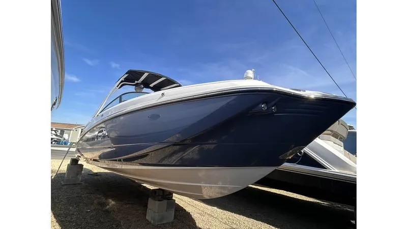 The Image of 2026 Monterey M65 boat on display under clear blue sky. - 1