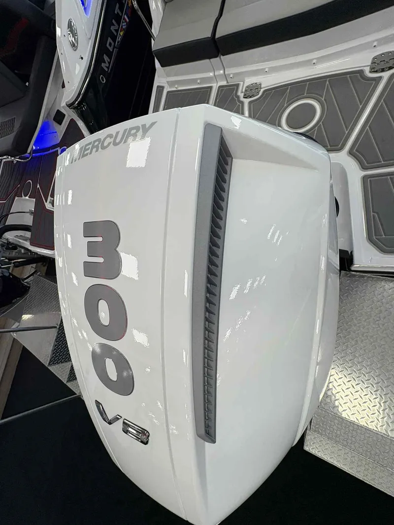 Slide: The Image of 2026 Monterey M65 boat with Mercury 300 V8 engine, sleek white design. - 21