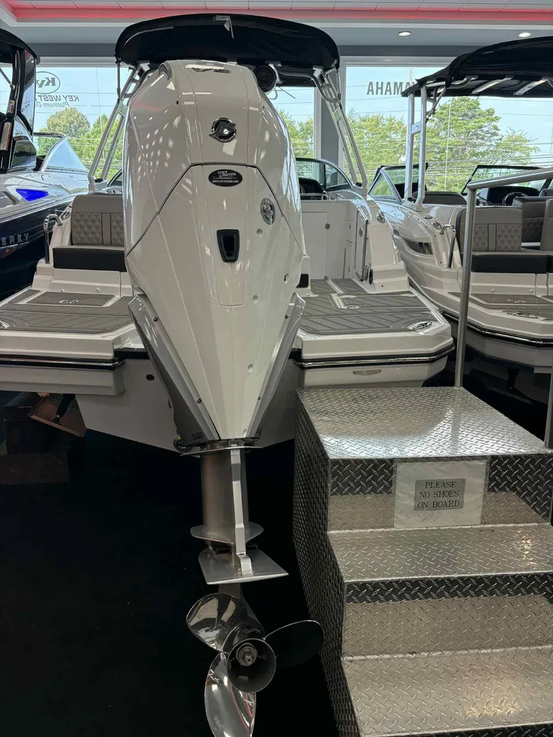 Slide: The Image of 2026 Monterey M65 boat displayed indoors with metal steps and "No Shoes" sign. - 22