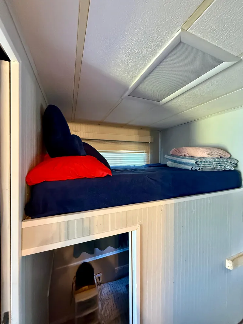 Slide: The Image of Loft bed with blue bedding in 1996 Jamestowner houseboat interior. - 10