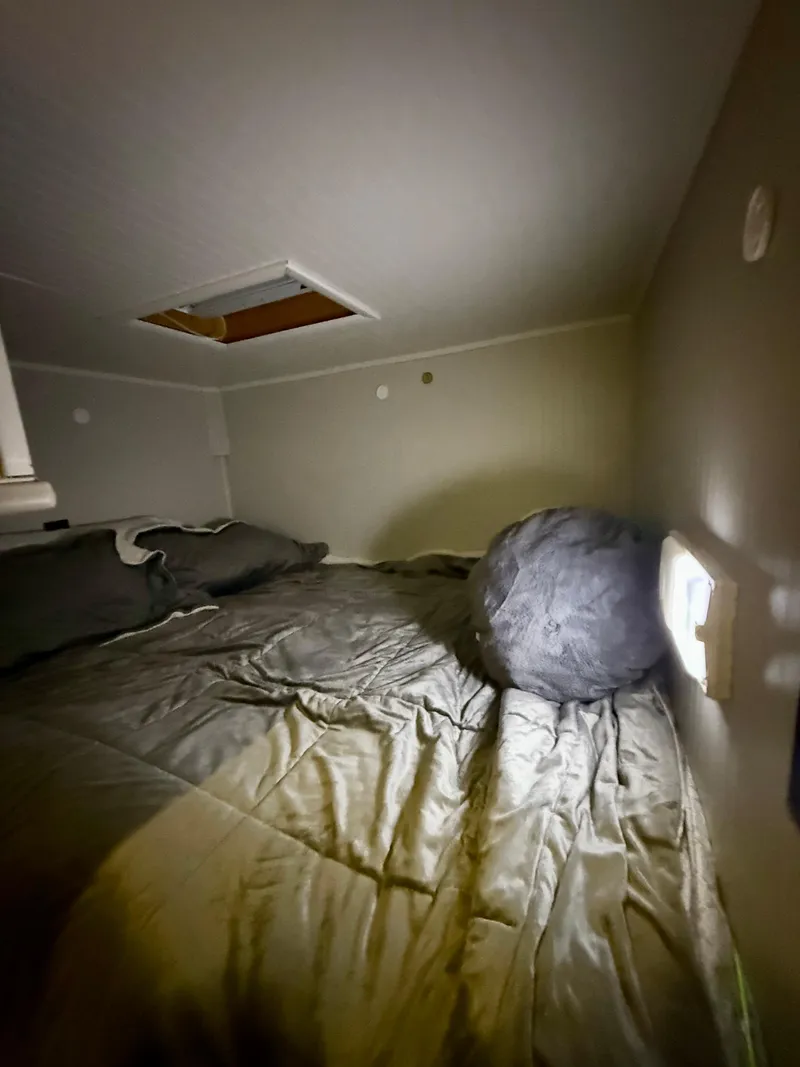 Slide: The Image of Cozy bedroom interior of a 1996 Jamestowner houseboat with bedding and soft lighting. - 13