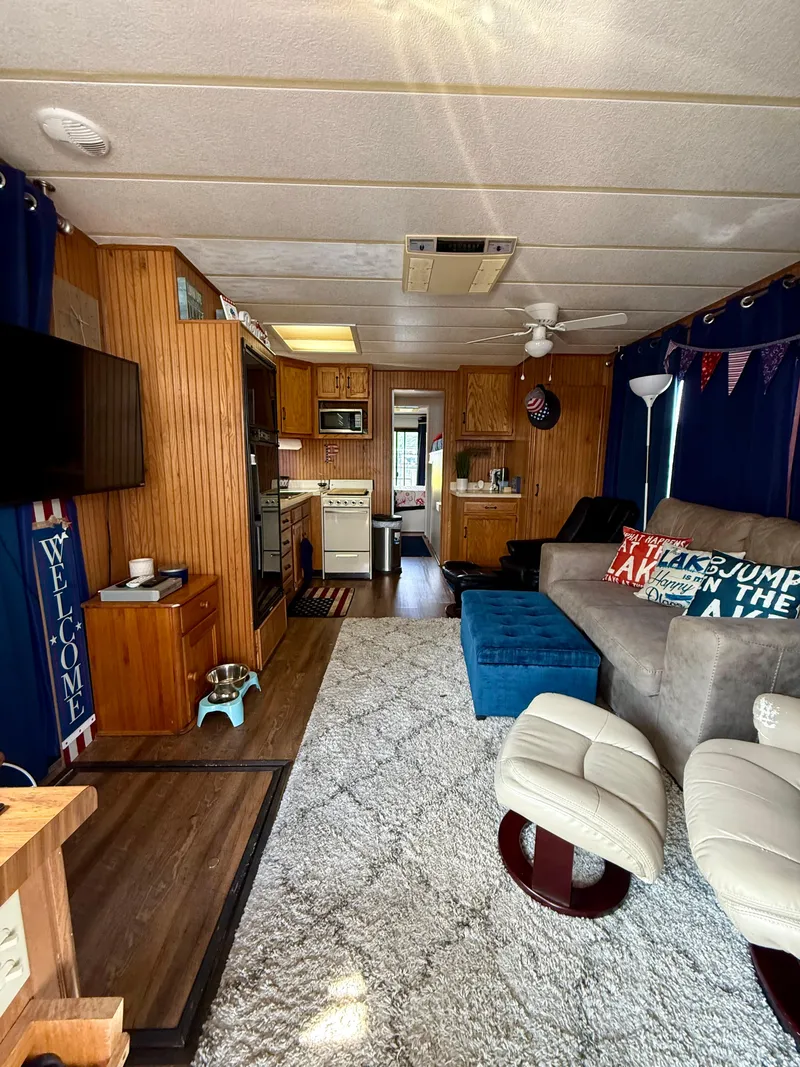 Slide: The Image of Interior of a 1996 Jamestowner houseboat with cozy living area and kitchen. - 5