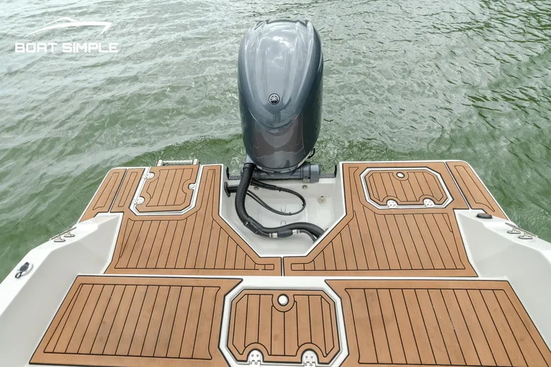 Slide: The Image of 2024 Starcraft SVX 211 OB boat with wooden deck and outboard motor on water. - 10