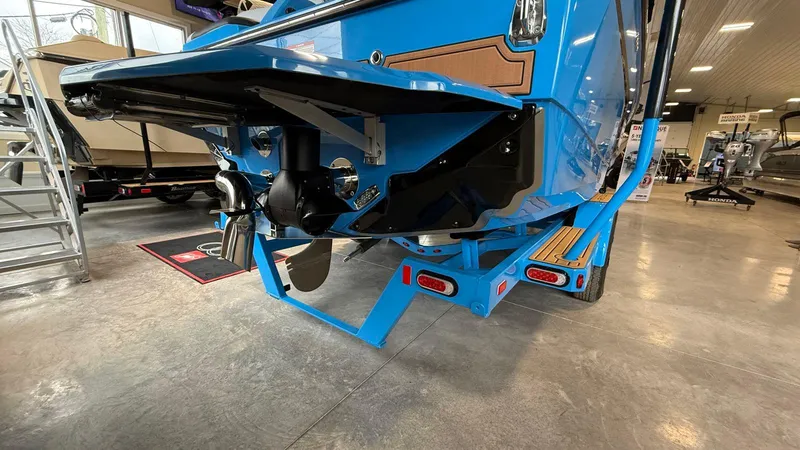 Slide: The Image of 2025 Nautique GS 24 boat in showroom, showcasing rear design and propeller. - 5