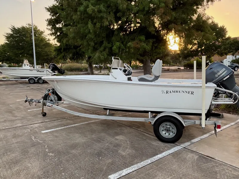 The Image of 2016 Sportsman Island Reef 17 Center Console boat on trailer in parking lot at sunset. - 0