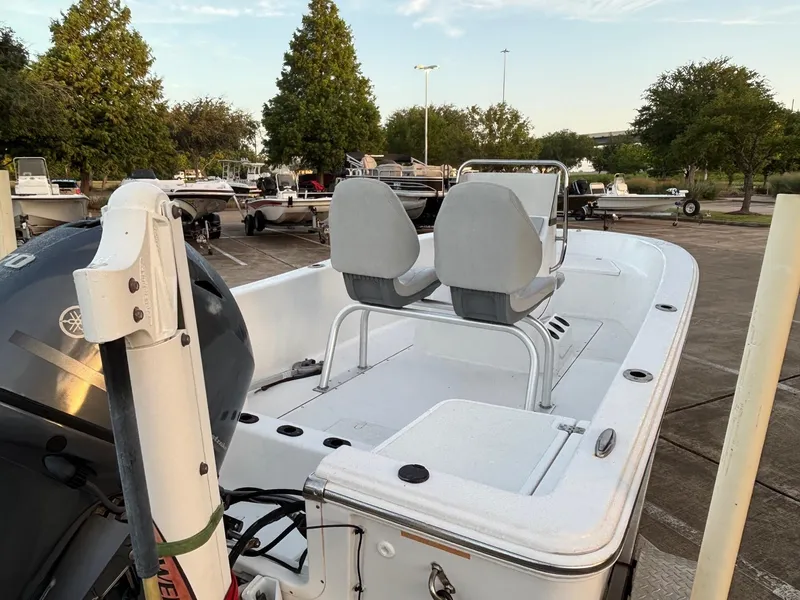 Slide: The Image of 2016 Sportsman Island Reef 17 Center Console boat in a parking lot, featuring dual seats. - 4