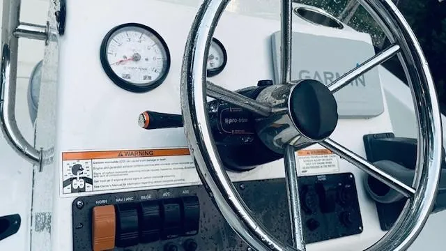 Slide: The Image of 2016 Sportsman Island Reef 17 Center Console dashboard with steering wheel and gauges. - 6