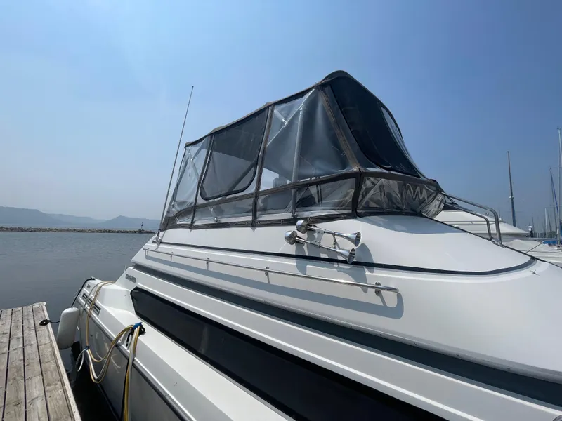 Slide: The Image of 1994 Carver 380 Santego SE yacht docked, featuring a sleek design and clear canopy. - 10