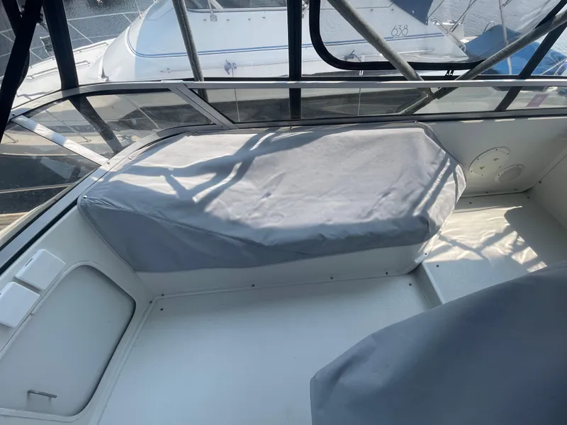 Slide: The Image of 1994 Carver 380 Santego SE boat interior with covered seating area. - 14