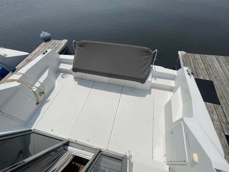 Slide: The Image of 1994 Carver 380 Santego SE boat deck with seating, docked by calm water. - 17