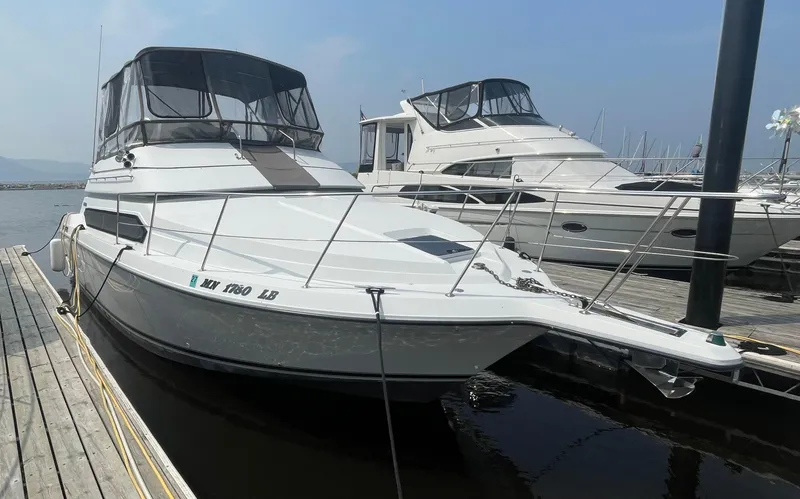 Slide: The Image of 1994 Carver 380 Santego SE yacht docked at marina, featuring sleek design and spacious deck. - 2