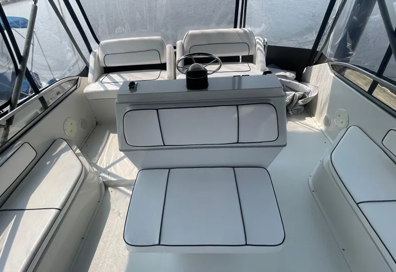 Slide: The Image of 1994 Carver 380 Santego SE boat interior with white seating and steering wheel. - 21