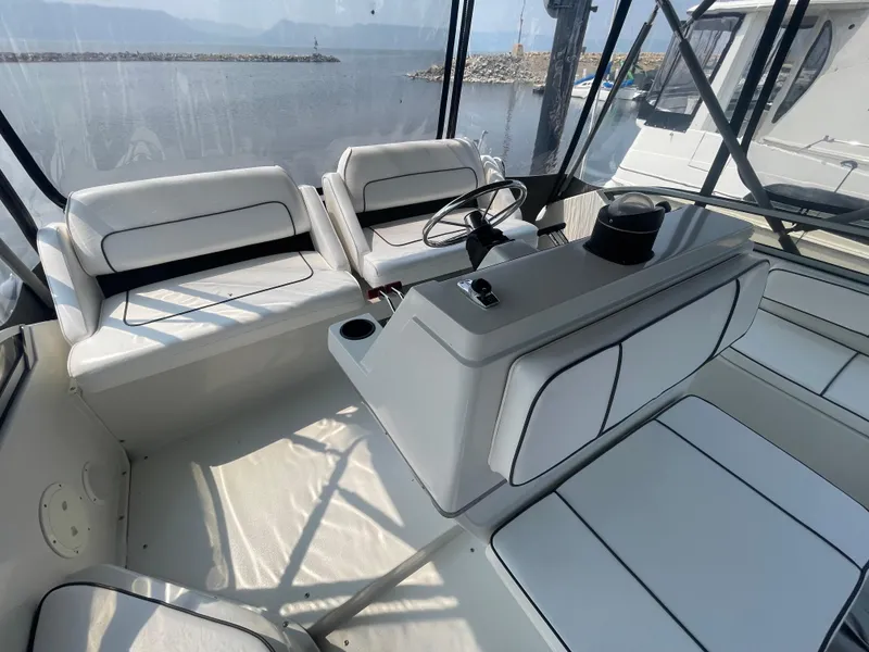 Slide: The Image of 1994 Carver 380 Santego SE boat interior with white seating and steering wheel. - 24