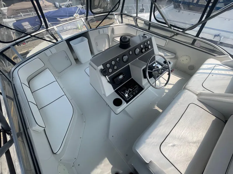 Slide: The Image of 1994 Carver 380 Santego SE boat interior with helm, seating, and control panel. - 25