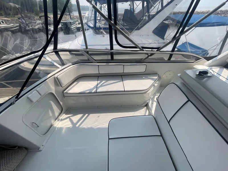 Slide: The Image of 1994 Carver 380 Santego SE boat interior with white seating and clear windows. - 28