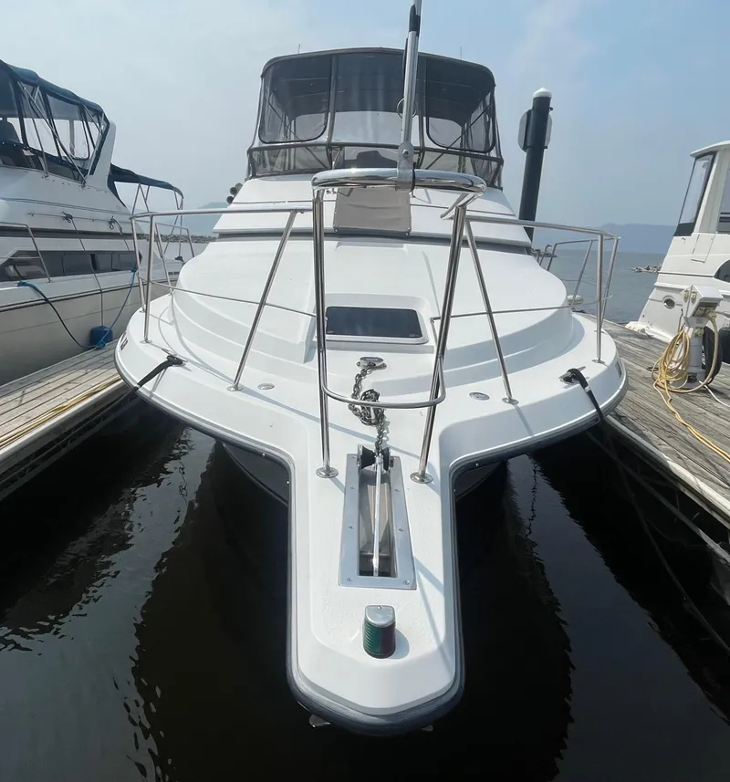 Slide: The Image of 1994 Carver 380 Santego SE yacht docked at marina, front view. - 3