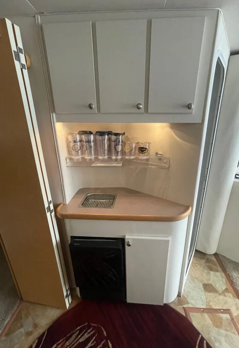 Slide: The Image of 1994 Carver 380 Santego SE interior kitchenette with cabinets and mini fridge. - 35