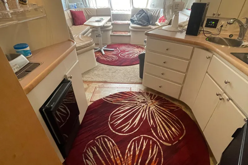 Slide: The Image of Interior of 1994 Carver 380 Santego SE yacht with kitchen and seating area. - 36
