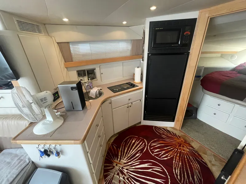 Slide: The Image of Interior of 1994 Carver 380 Santego SE yacht with kitchen and cozy bedroom. - 37