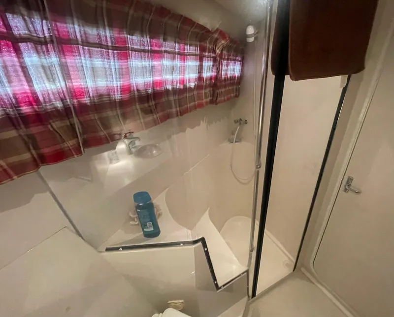 Slide: The Image of Bathroom interior of 1994 Carver 380 Santego SE yacht with shower and plaid curtain. - 39