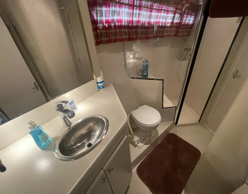 Slide: The Image of Bathroom interior of 1994 Carver 380 Santego SE yacht with sink, toilet, and shower. - 41