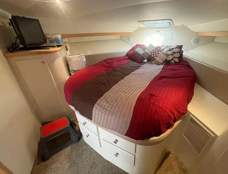 Slide: The Image of Cozy bedroom in 1994 Carver 380 Santego SE yacht with red bedding and TV. - 42