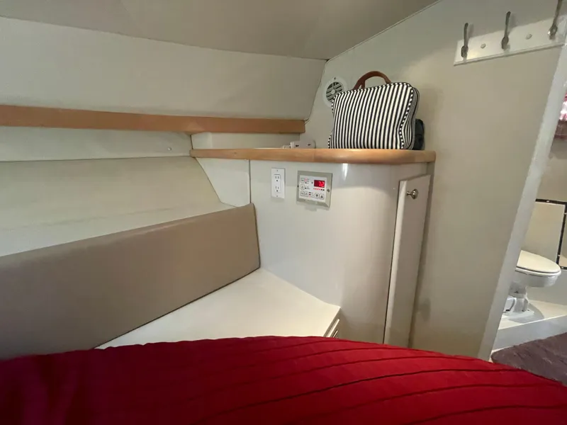 Slide: The Image of Interior of 1994 Carver 380 Santego SE boat with seating, storage, and bathroom. - 43