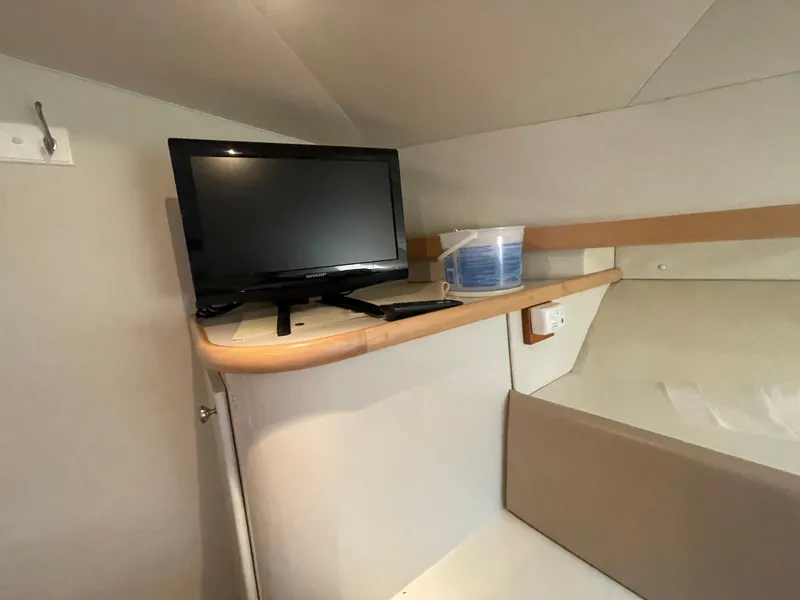Slide: The Image of Interior of 1994 Carver 380 Santego SE with TV and storage shelf. - 45