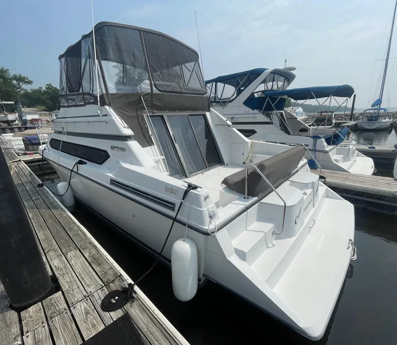 Slide: The Image of 1994 Carver 380 Santego SE yacht docked at marina, featuring sleek design and spacious deck. - 5