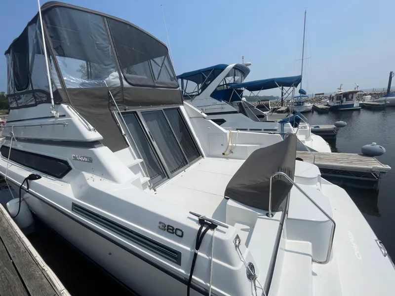 Slide: The Image of 1994 Carver 380 Santego SE yacht docked at marina, featuring sleek design and spacious deck. - 7