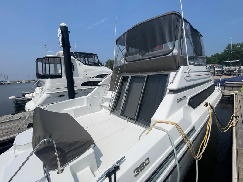 Slide: The Image of 1994 Carver 380 Santego SE yacht docked at marina, featuring sleek design and spacious deck. - 8