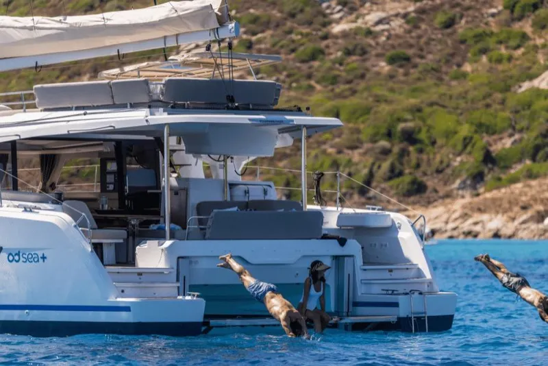 Slide: The Image of 2026 Fountaine Pajot 44 yacht with people diving into the sea. - 41