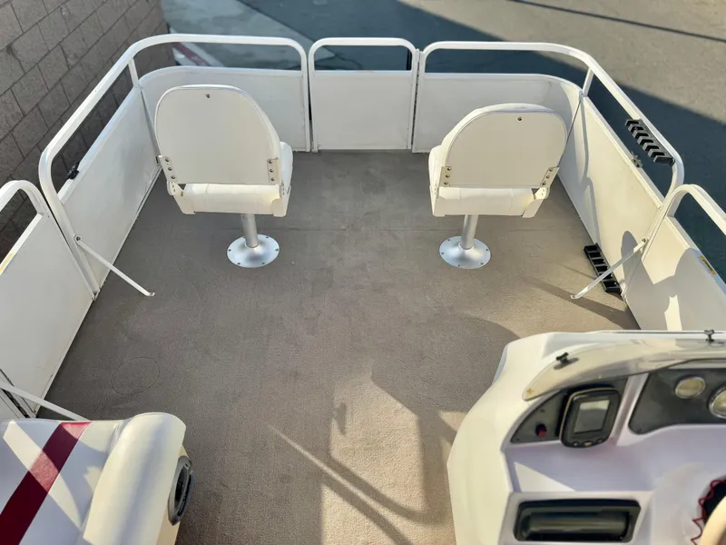 Slide: The Image of 2006 Godfrey Tuscany 2080 pontoon boat interior with two white seats and steering console. - 10