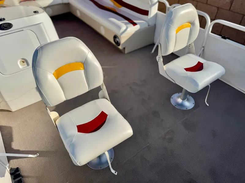 Slide: The Image of Two swivel seats on a 2006 Godfrey Tuscany 2080 boat interior. - 12