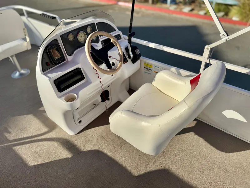 Slide: The Image of 2006 Godfrey Tuscany 2080 boat helm with steering wheel and captain's chair. - 14