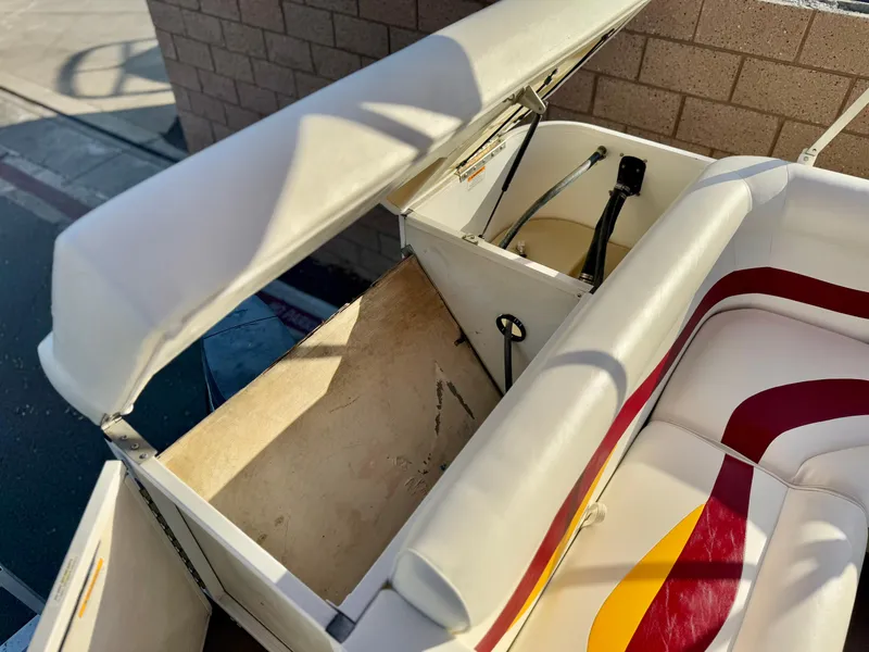 Slide: The Image of Open storage compartment on 2006 Godfrey Tuscany 2080 boat with white and red seating. - 17