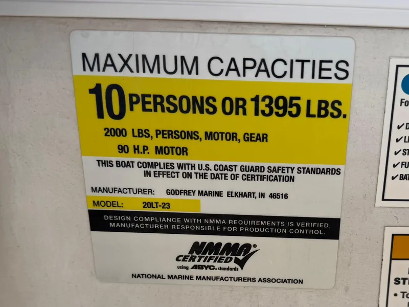 Slide: The Image of Capacity label for Godfrey Tuscany 2080, 2006 model, 10 persons or 1395 lbs, 90 HP motor. - 18