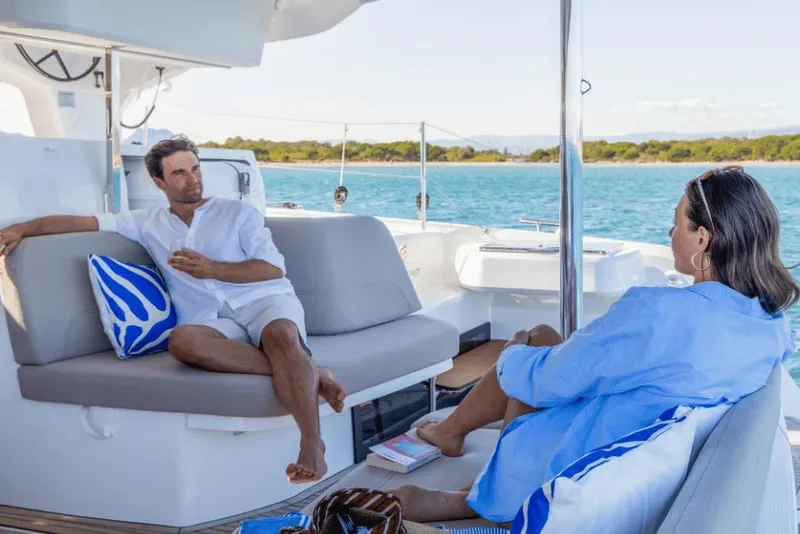 Slide: The Image of Couple relaxing on a 2026 Fountaine Pajot 44 yacht, enjoying the scenic ocean view. - 19