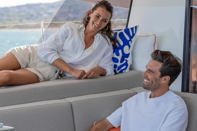 Slide: The Image of Couple relaxing on a 2026 Fountaine Pajot 44 yacht, enjoying a sunny day. - 23