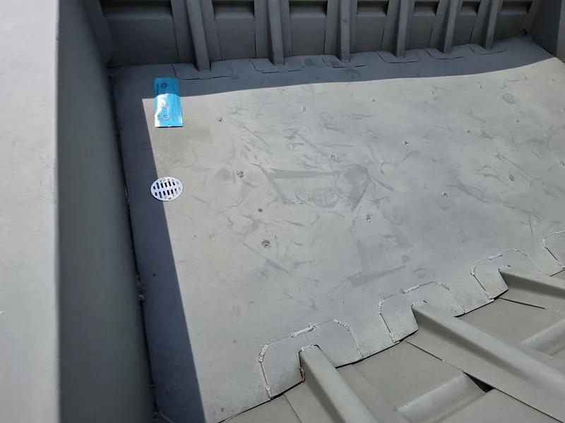 Slide: The Image of Interior of 2023 Weldcraft 1544-CDS boat, featuring a clean, gray metal floor. - 10